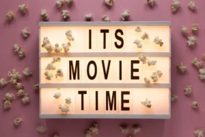 A lightbox displaying the words "IT'S MOVIE TIME" surrounded by scattered popcorn