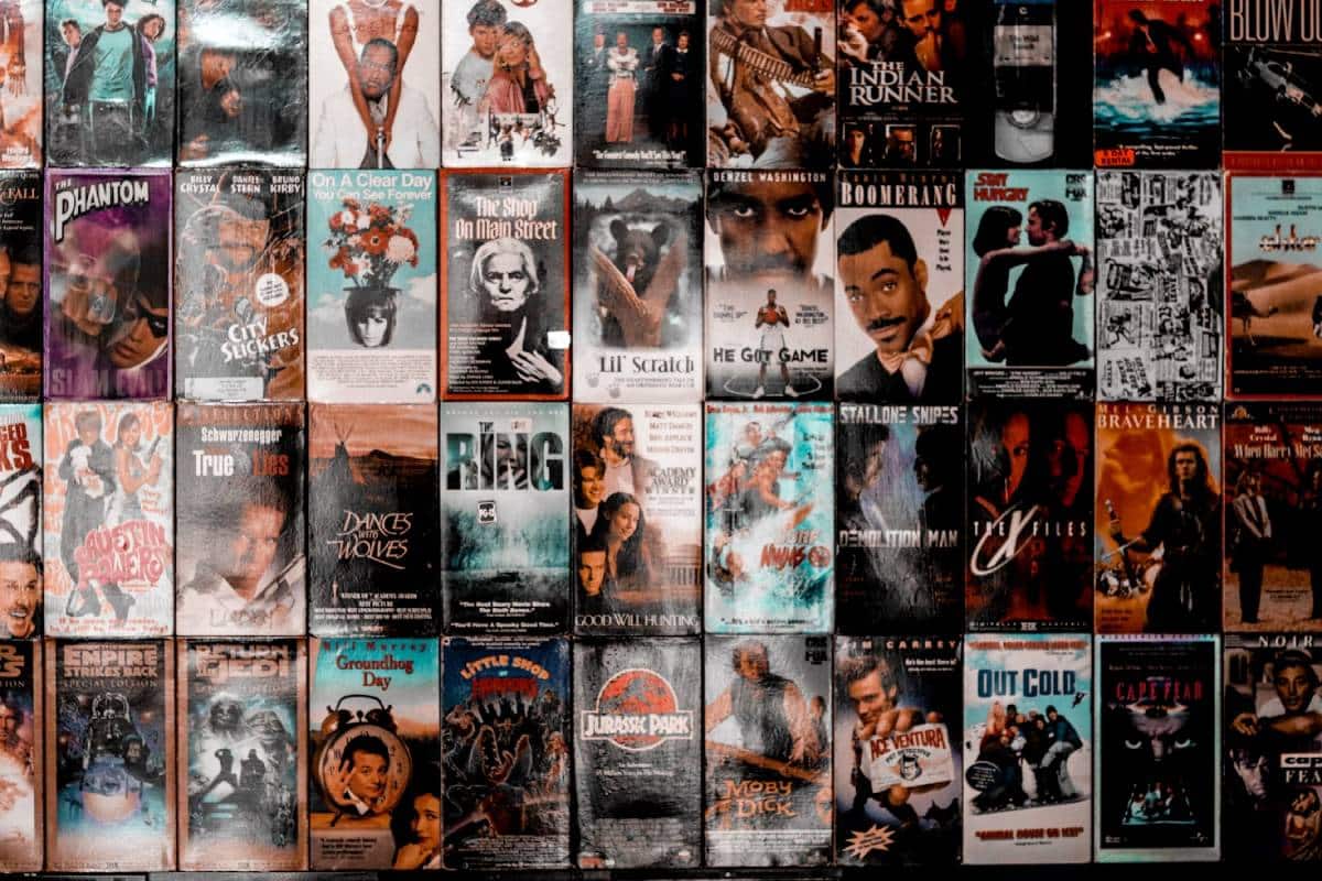 A collage of various VHS covers, showcasing iconic movies like "Braveheart," "Jurassic Park," and "The Ring," with vibrant artwork.