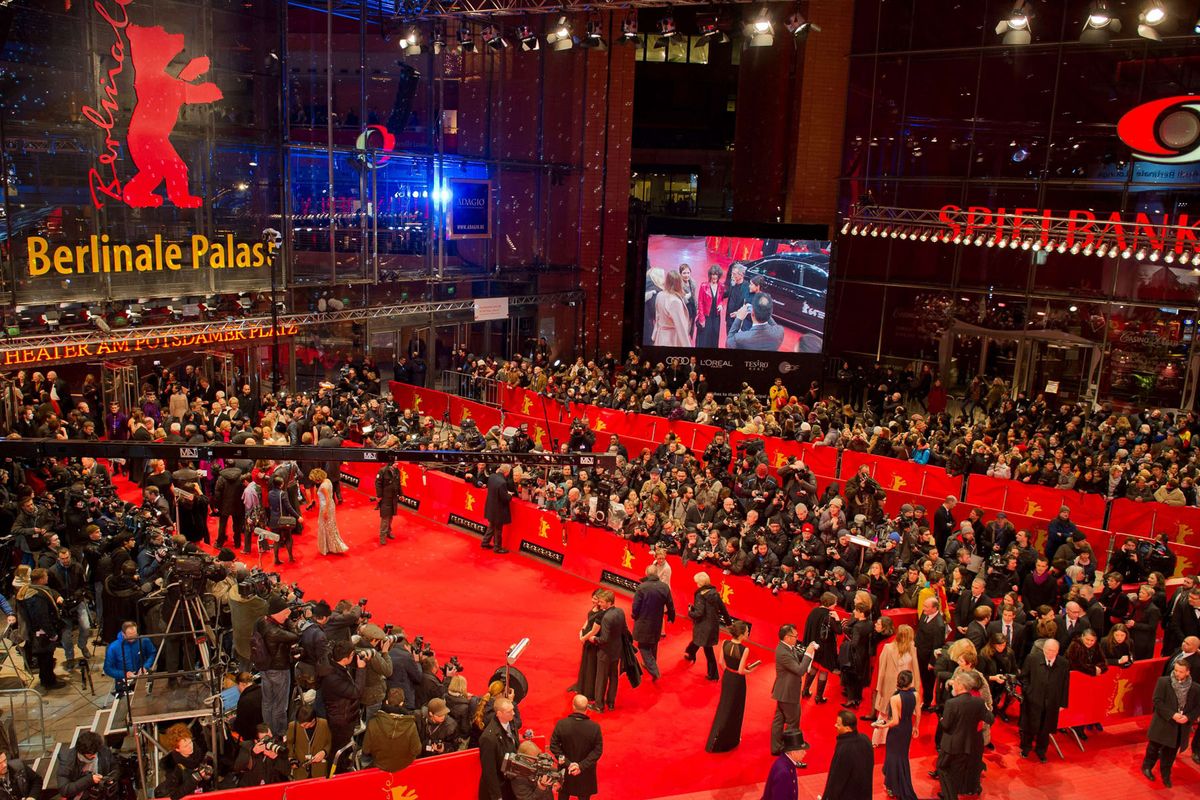 The bustling red carpet at the Berlinale Palast, filled with celebrities, photographers, and fans during the Berlin International Film Festival.